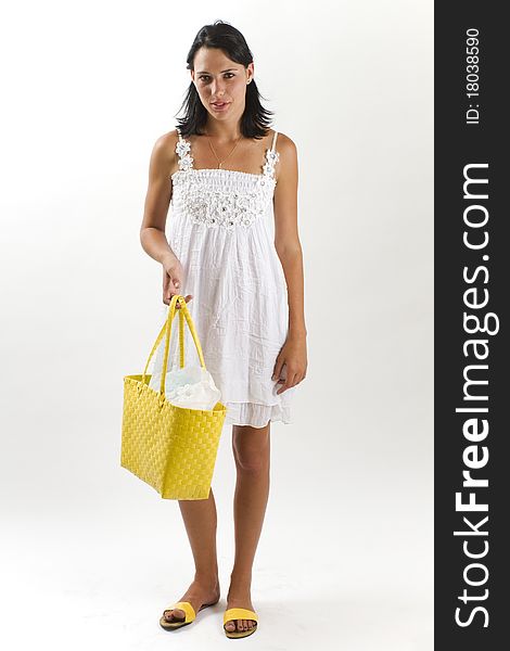 Woman in white summer dress with shopping bag