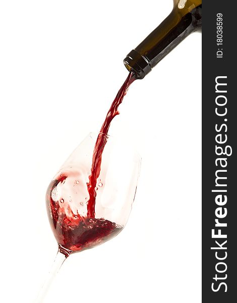 Red wine splash on a glass, white background.