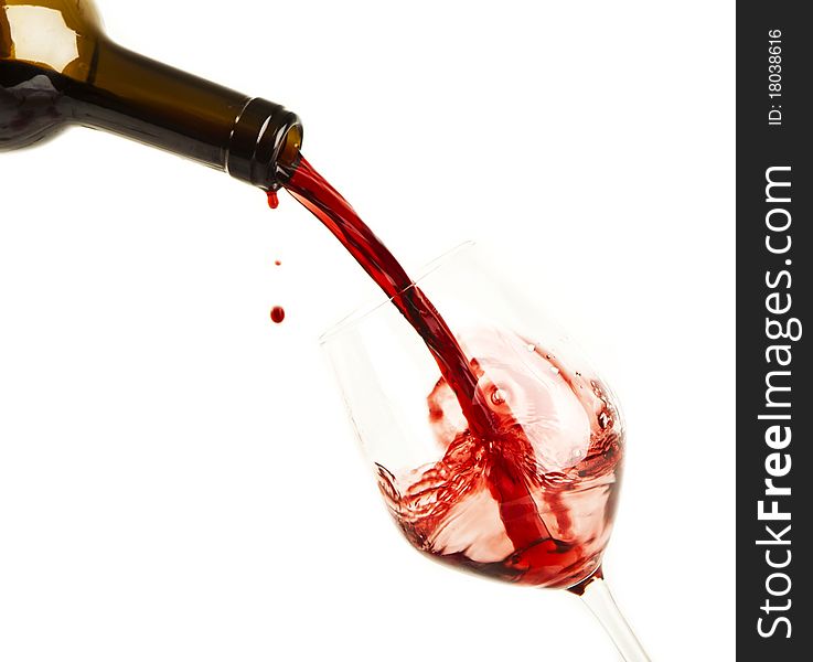 Red wine splash on a glass, white background.