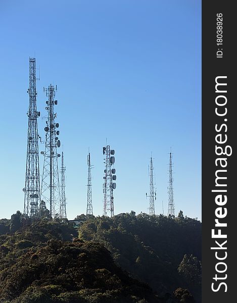 Telecommunications towers, relays and mobile radio antennas in forest.