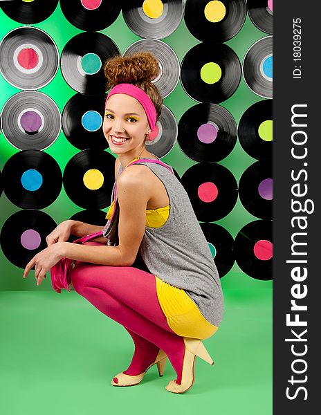 Studio shot of cheerful teenage girl over colorful background