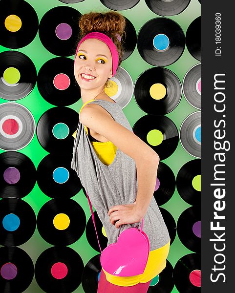 Studio shot of cheerful teenage girl over colorful background