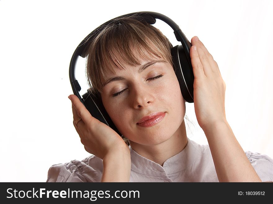Girl listening music isolated on white