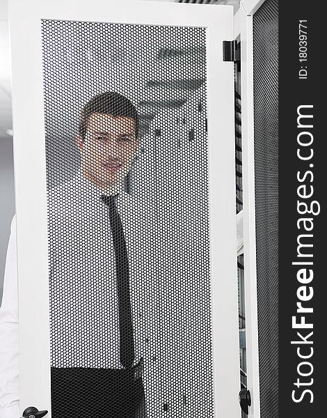 Young handsome business man it engeneer in datacenter server room. Young handsome business man it engeneer in datacenter server room