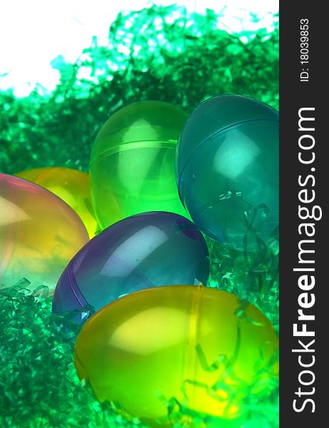 Colorful plastic Easter eggs in fake grass