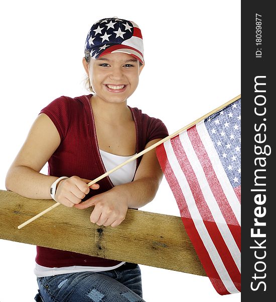 A pretty young teen in casual garb wearing a stars and stripes hat and waving a flag. Isolated on white. A pretty young teen in casual garb wearing a stars and stripes hat and waving a flag. Isolated on white.
