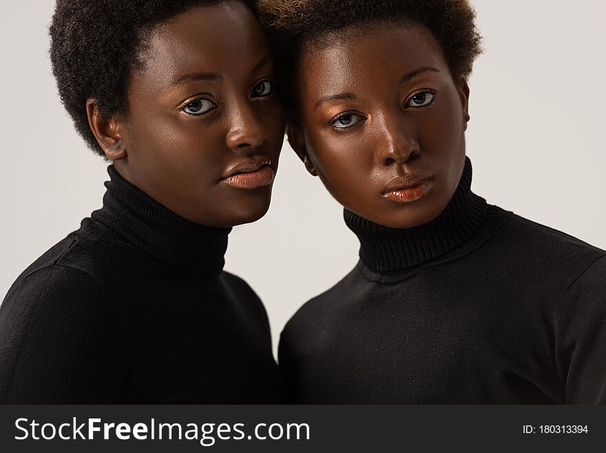 african american women in black turtlenecks isolated on grey. african american women in black turtlenecks isolated on grey
