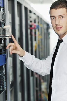 Young It Engeneer In Datacenter Server Room Royalty Free Stock Photography Young It Engeneer In Datacenter Server Room Royalty Free Stock Photography