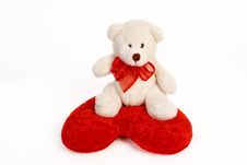 White Teddy Bear Sitting On A Heart Shaped Pillow Stock Images