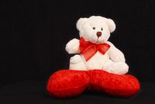 White Teddy Bear Sitting On A Heart Shaped Pillow Royalty Free Stock Images White Teddy Bear Sitting On A Heart Shaped Pillow Royalty Free Stock Images