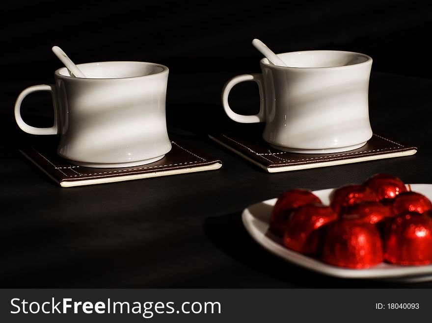 Two tea cups with sweets. Two tea cups with sweets.