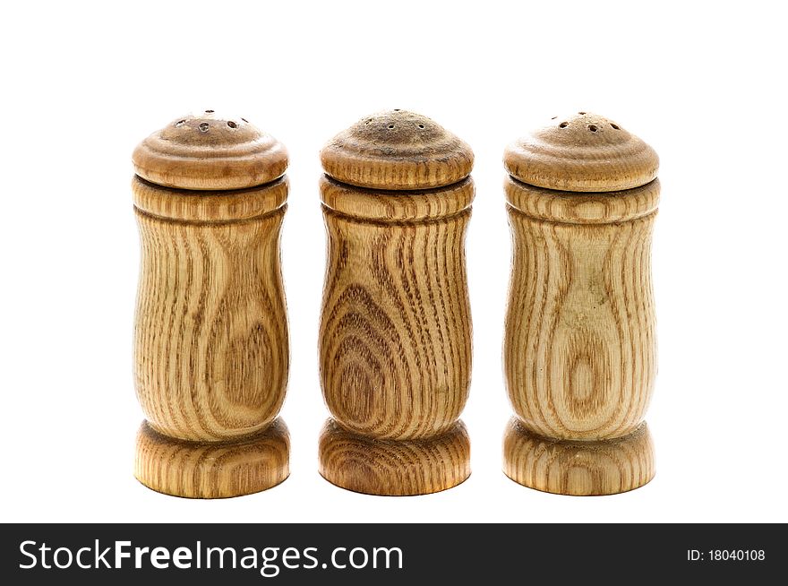 Salt, pepper and paprika in wooden condiments container isolated on a white background