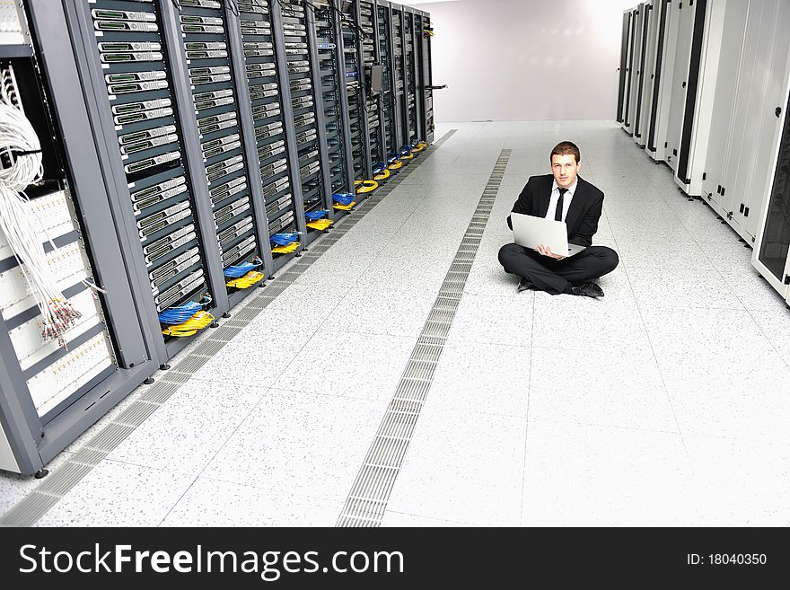 Young handsome business man it  engeneer in datacenter server room. Young handsome business man it  engeneer in datacenter server room