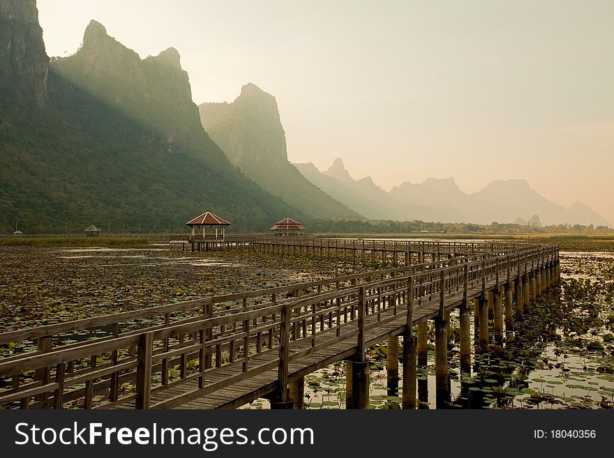 Footbridge in lake into the mountain, thailand