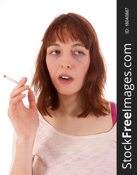 A young woman has a cigarette in her hand. A young woman has a cigarette in her hand