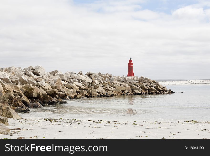 Breakwater wall with gas-powered, unmanned lighthouse at end, Lambert's Bay, Western Cape, South Africa. Breakwater wall with gas-powered, unmanned lighthouse at end, Lambert's Bay, Western Cape, South Africa.