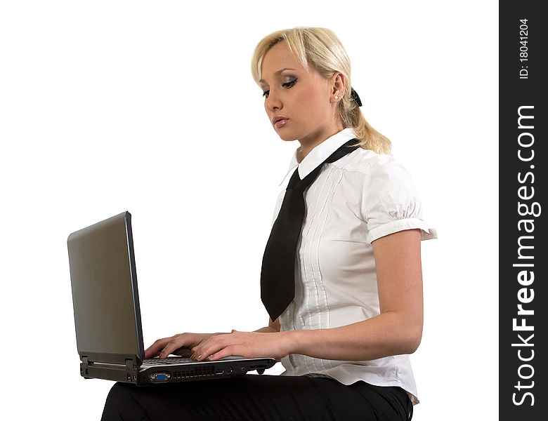 Blond girl working at a laptop isolated on white. Blond girl working at a laptop isolated on white.