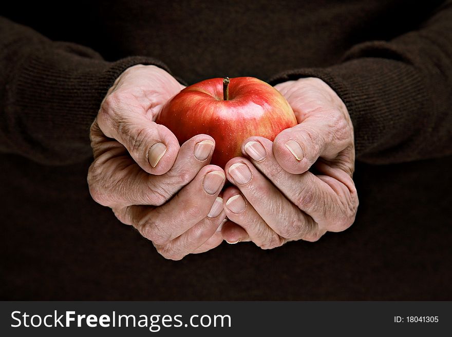 Senior woman holding a red organic apple. Senior woman holding a red organic apple