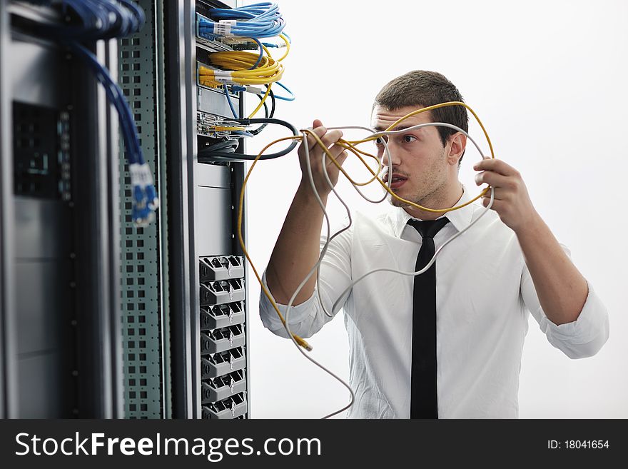 Young handsome business man it engeneer in datacenter server room. Young handsome business man it engeneer in datacenter server room