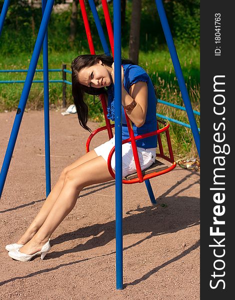 Portrait of a smiling young girl on a swing hunging backwards. Portrait of a smiling young girl on a swing hunging backwards