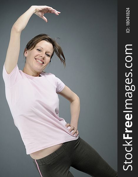 Happy white woman teaching aerobic exercises. Happy white woman teaching aerobic exercises