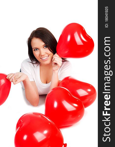 Beautiful young brunette with red hearts isolated on white background