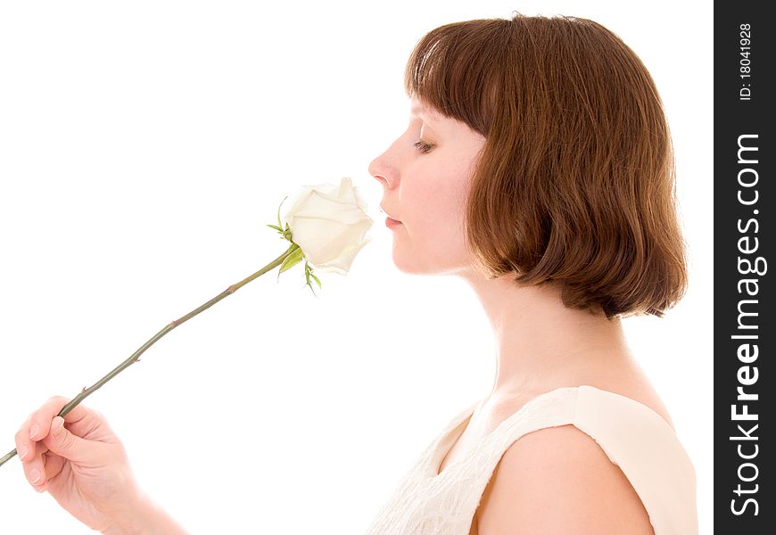 Girl sniffs a rose on a white background. Girl sniffs a rose on a white background.