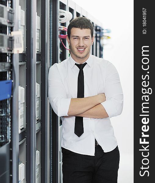 Young handsome business man it  engeneer in datacenter server room. Young handsome business man it  engeneer in datacenter server room
