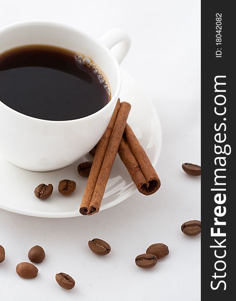 Coffee cup and cinnamon sticks