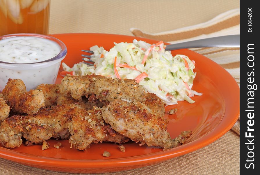 Breaded chicken strips with coleslaw and dipping sauce