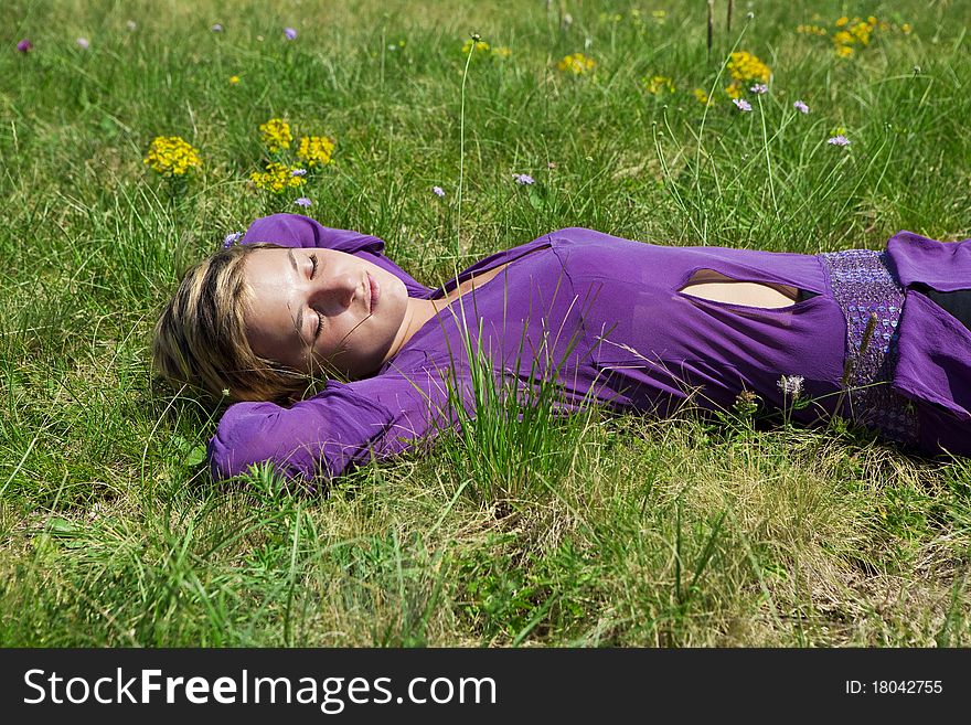 Young Girl Relaxing On The Grass