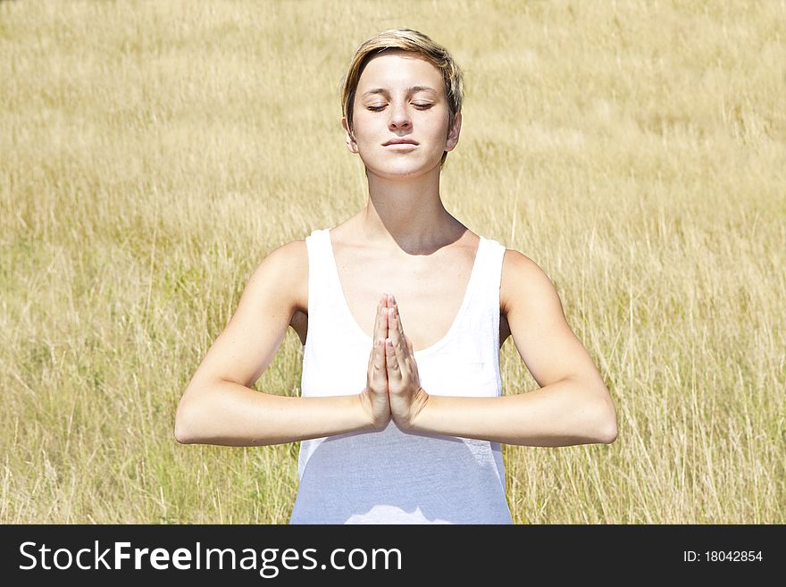 Young woman practicing yoga outdoor in summer