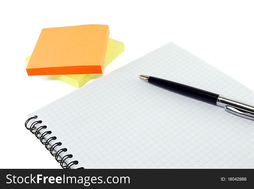 Notebook with the handle and a multi-colored paper it is isolated on a white background