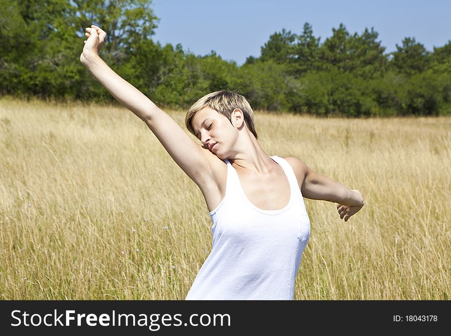 Young girl enjoying freedom in a field in summer