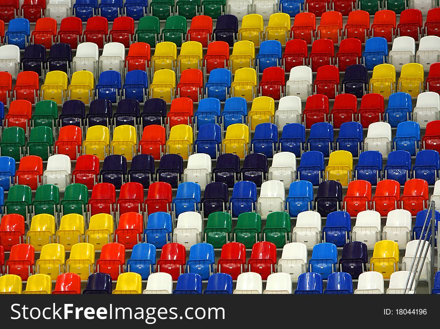 Perspective of rows multicolored seats on the sport tribune