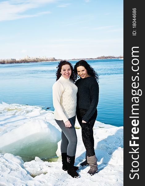 Girls twins near river in winter