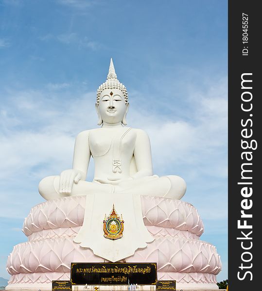 White Buddha statue with blue sky.