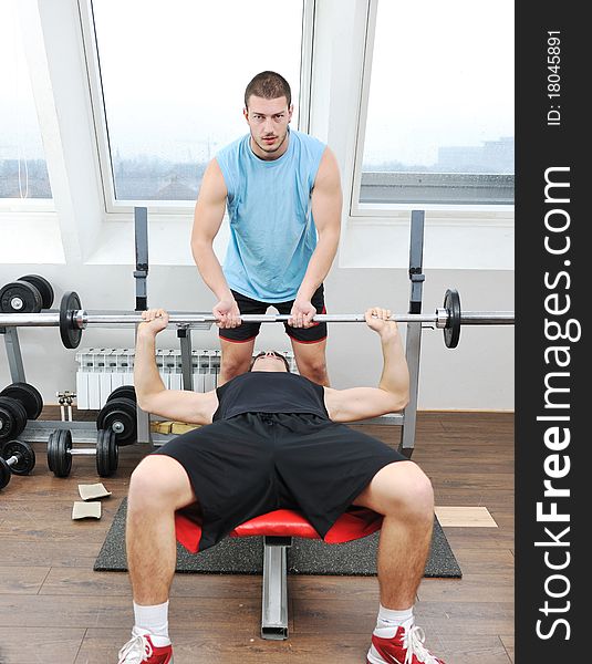 Young man in fintess sport club exercise withweights and relaxing. Young man in fintess sport club exercise withweights and relaxing