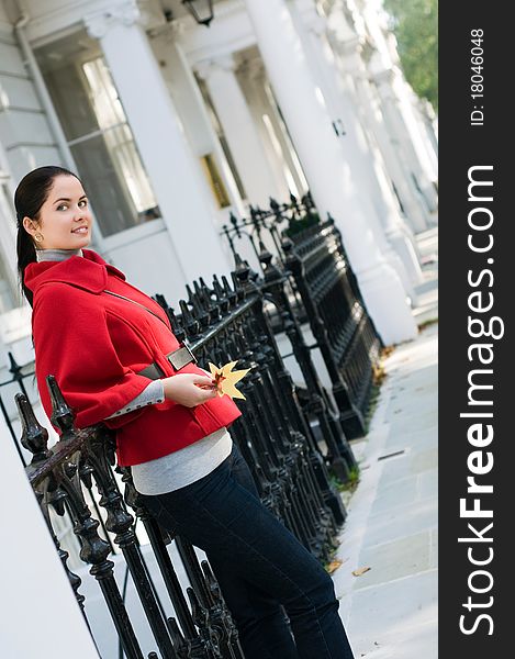 Young women in red coat on the street