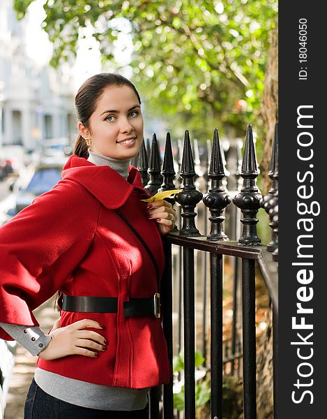 Young women in red coat on the street