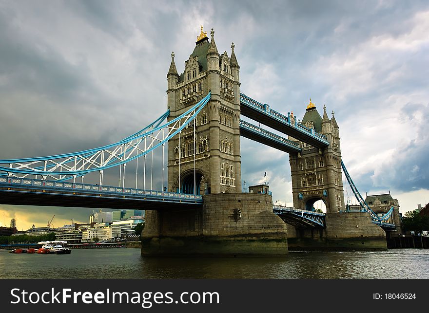 Tower Bridge against a dramatic cloudy sky background, London, UK