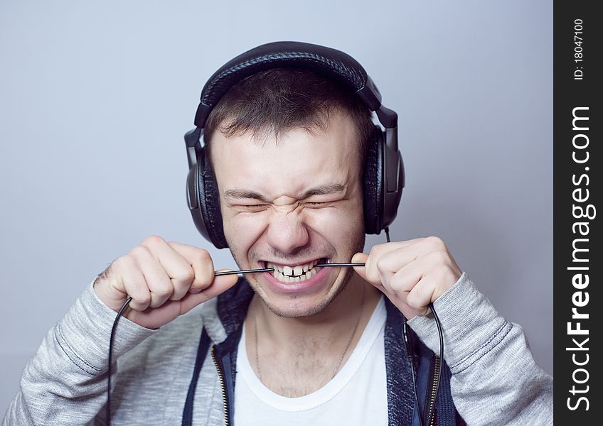 Guy with headphones eats cable