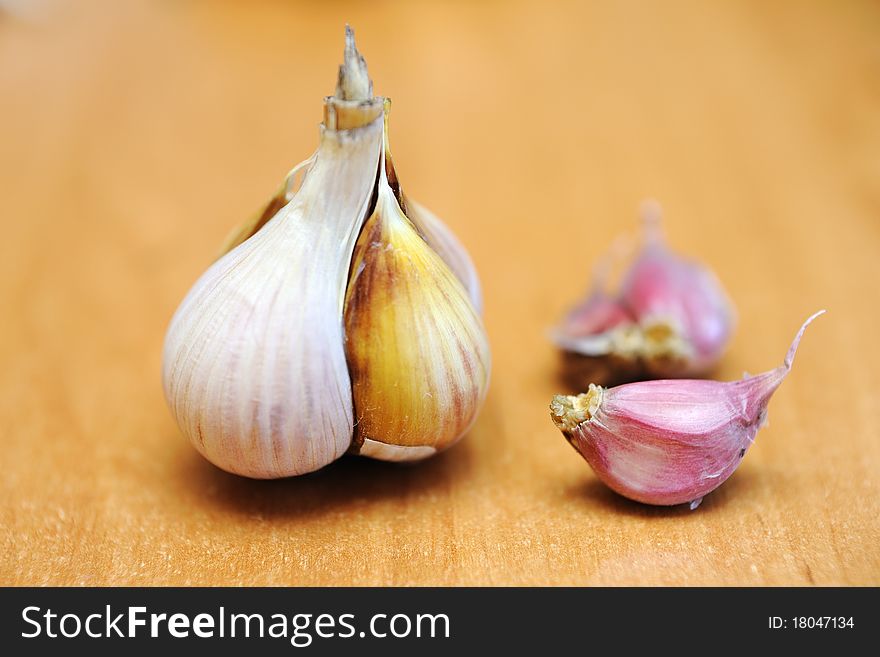 An image of garlic on wooden table