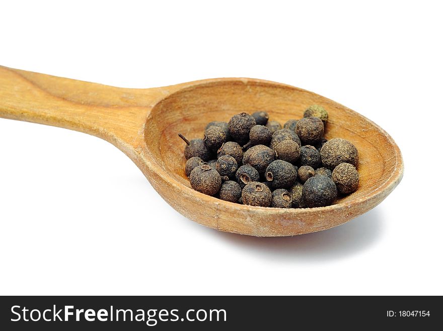 An image of pea pepper in wooden spoon. An image of pea pepper in wooden spoon