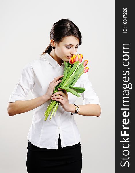 An image of young businesswoman with tulips