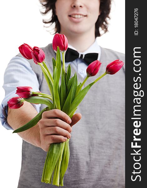 A young boy with a bouquet of red tulips. A young boy with a bouquet of red tulips