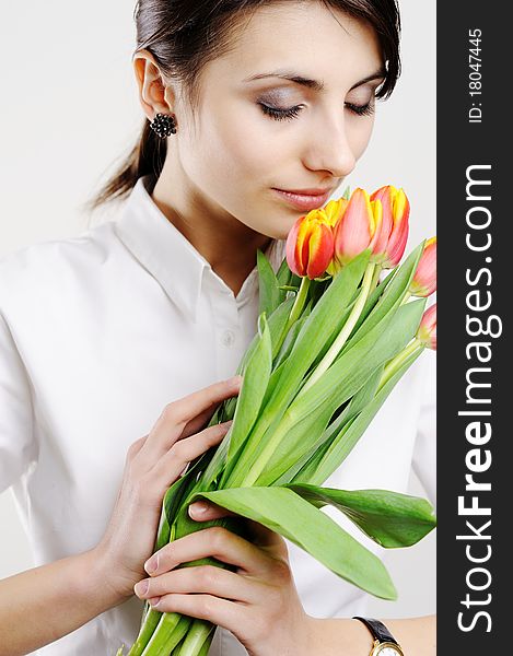 An image of young girl with fresh tulips. An image of young girl with fresh tulips