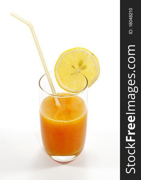 Fresh juice isolated on white background with a lemon on it.