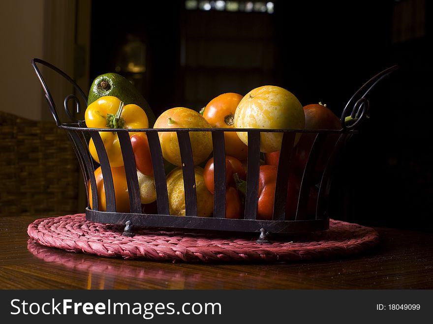 Assorted vegetable basket on kitchen table. Assorted vegetable basket on kitchen table