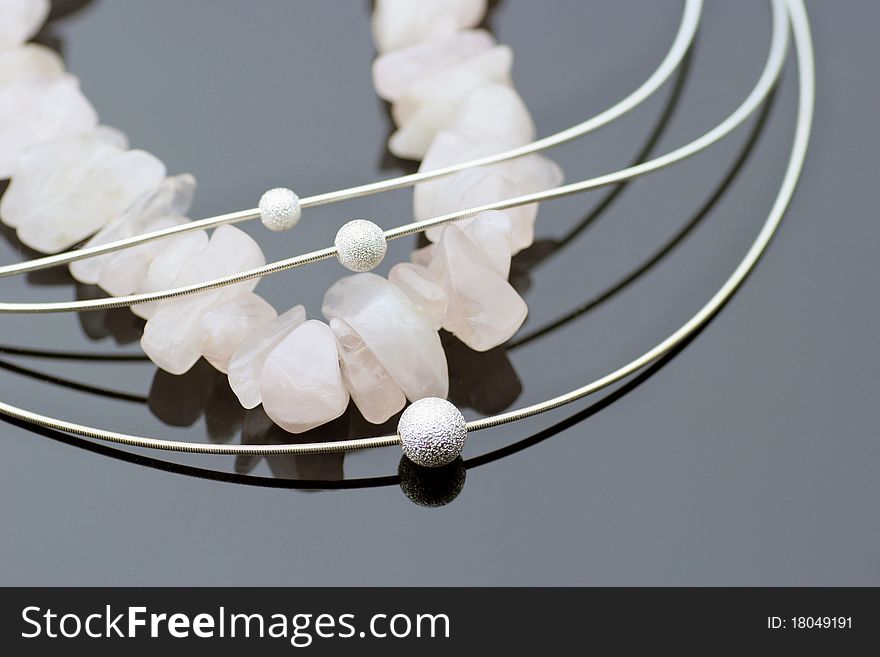 Arrangement of four pieces of necklaces on black background